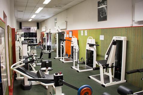 Fitnessgeräte im Kraftraum Blick auf verschiedene Fitnessgeräte im Kraftraum der Jahnhalle, aufgestellt entlang einer Wand.